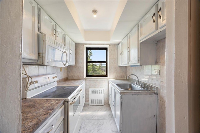 2545 Sedgwick Ave Unit 3B, Bronx, NY 10463 - kitchen with white appliances, a sink, light marble finish floors, radiator heating unit, and white cabinetry