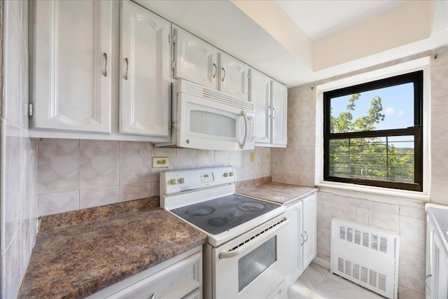 2545 Sedgwick Ave Unit 3B, Bronx, NY 10463 - kitchen featuring radiator, white appliances, white cabinets, and backsplash