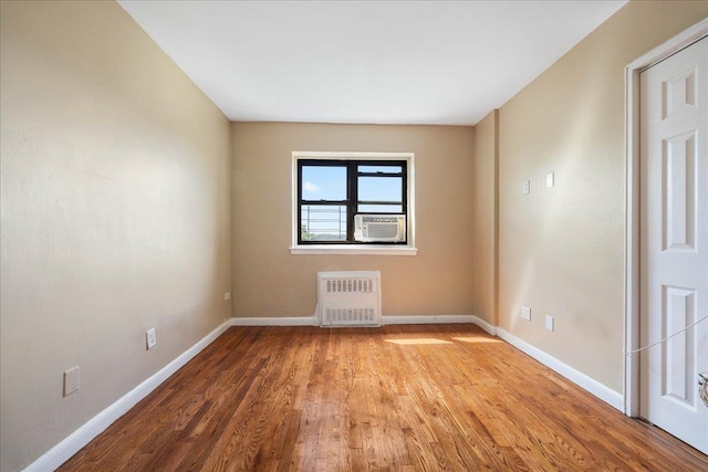 2545 Sedgwick Ave Unit 3B, Bronx, NY 10463 - spare room with radiator, baseboards, wood finished floors, and cooling unit
