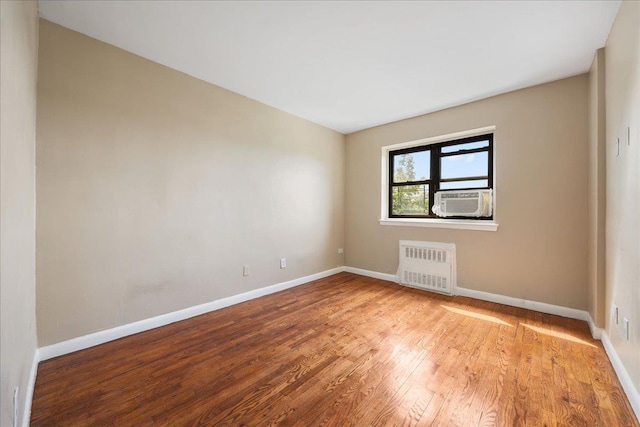 2545 Sedgwick Ave Unit 3B, Bronx, NY 10463 - unfurnished room with radiator heating unit, baseboards, wood finished floors, and cooling unit