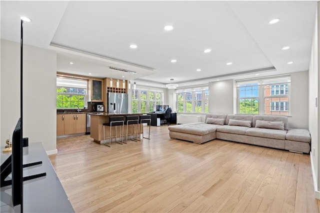 150 Oceana Dr W Unit 4B, Brooklyn, NY 11235 - living area with light wood-type flooring, a tray ceiling, healthy amount of natural light, and recessed lighting