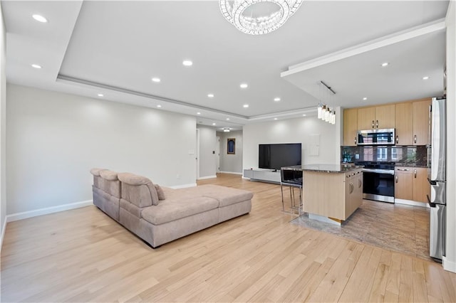 150 Oceana Dr W Unit 4B, Brooklyn, NY 11235 - living area with a tray ceiling, light wood-type flooring, baseboards, a chandelier, and recessed lighting