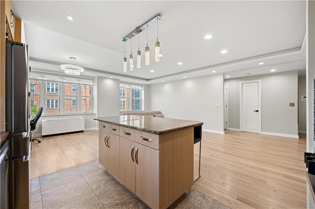 150 Oceana Dr W Unit 4B, Brooklyn, NY 11235 - kitchen with stainless steel appliances, a center island, a breakfast bar, open floor plan, and baseboards