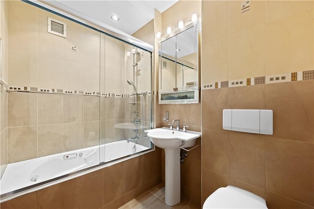 150 Oceana Dr W Unit 4B, Brooklyn, NY 11235 - full bath featuring tile walls, tiled shower / bath, toilet, a sink, and tile patterned flooring