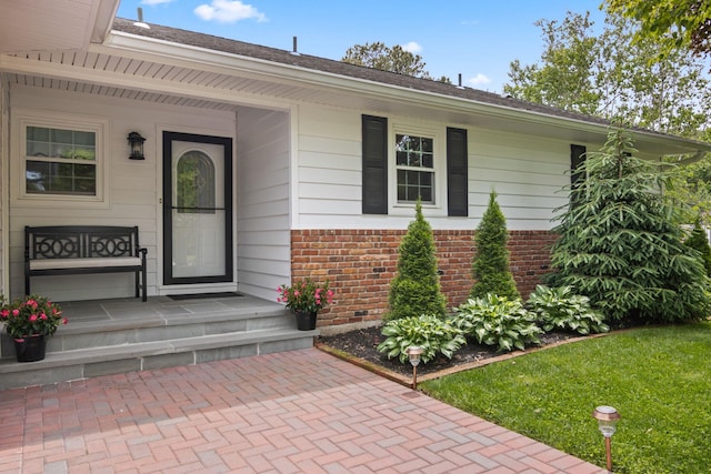 18 Chivalry Ln, Nesconset, NY 11767 - property entrance featuring brick siding, a porch, and a yard