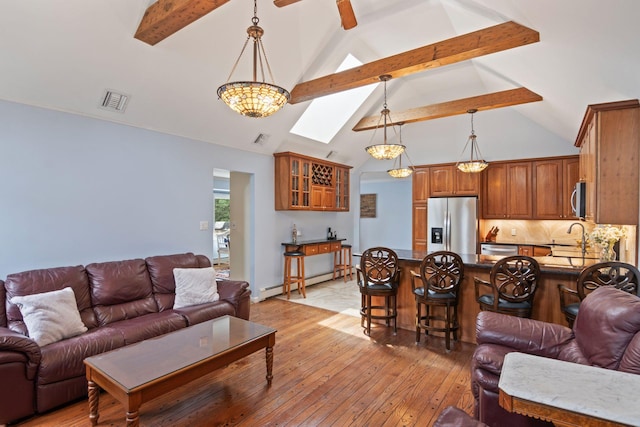 18 Chivalry Ln, Nesconset, NY 11767 - living room with beam ceiling, high vaulted ceiling, light wood-type flooring, a baseboard heating unit, and a skylight
