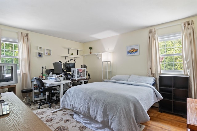 18 Chivalry Ln, Nesconset, NY 11767 - bedroom featuring multiple windows, wood finished floors, and a desk