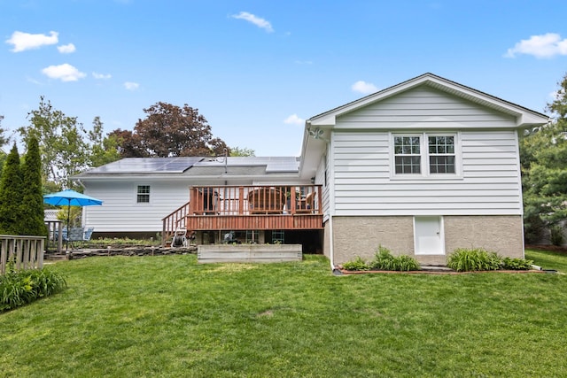 18 Chivalry Ln, Nesconset, NY 11767 - rear view of house with solar panels, a wooden deck, and a yard