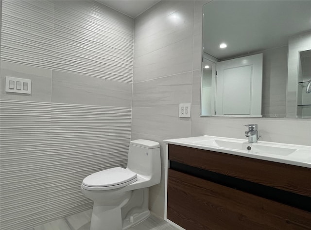 132-27 41st Rd Unit 4A, Flushing, NY 11355 - bathroom featuring toilet, vanity, and tile walls
