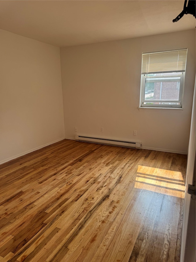 25-72 127th St, Flushing, NY 11354 - unfurnished room with a baseboard radiator and wood finished floors