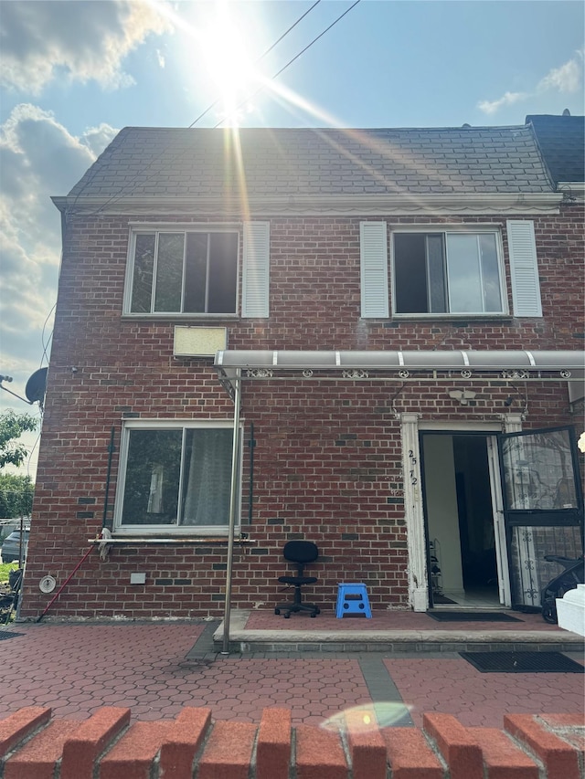 25-72 127th St, Flushing, NY 11354 - back of house with a patio and brick siding