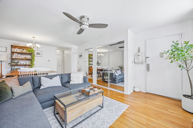 219 Berry St Unit 2, Brooklyn, NY 11249 - living room with a chandelier, ceiling fan, and light wood-type flooring
