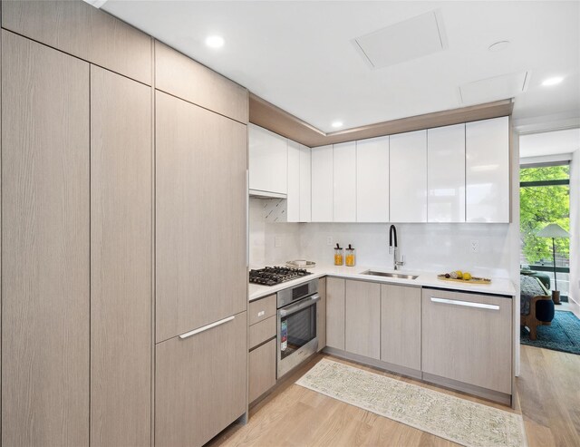 38-20 Parsons Blvd Unit 516, Flushing, NY 11354 - kitchen with appliances with stainless steel finishes, a sink, light wood-style floors, light countertops, and recessed lighting