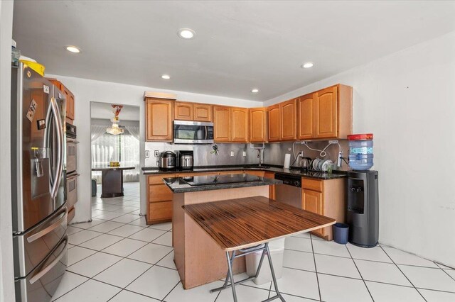 204 Carnation Dr, Farmingdale, NY 11735 - kitchen featuring stainless steel appliances, decorative backsplash, recessed lighting, a sink, and brown cabinetry