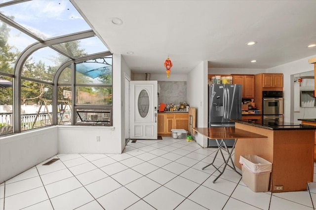 204 Carnation Dr, Farmingdale, NY 11735 - kitchen with appliances with stainless steel finishes, dark countertops, brown cabinets, a sunroom, and a kitchen bar