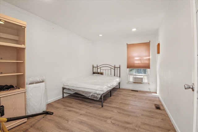 204 Carnation Dr, Farmingdale, NY 11735 - bedroom with wood finished floors, cooling unit, recessed lighting, and baseboards