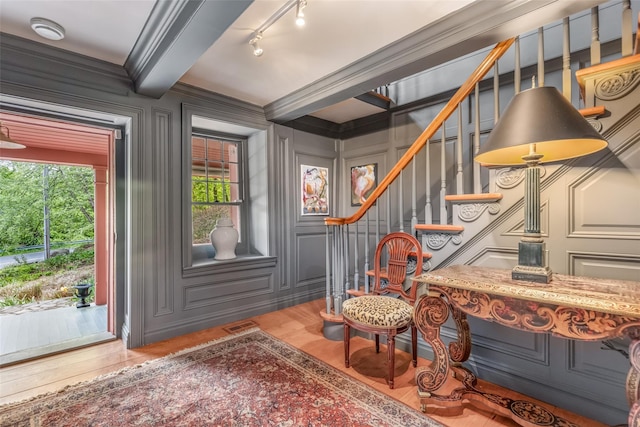 1282 Old Post Rd, Ulster Park, NY 12487 - entrance foyer featuring wood finished floors, a decorative wall, stairway, and crown molding
