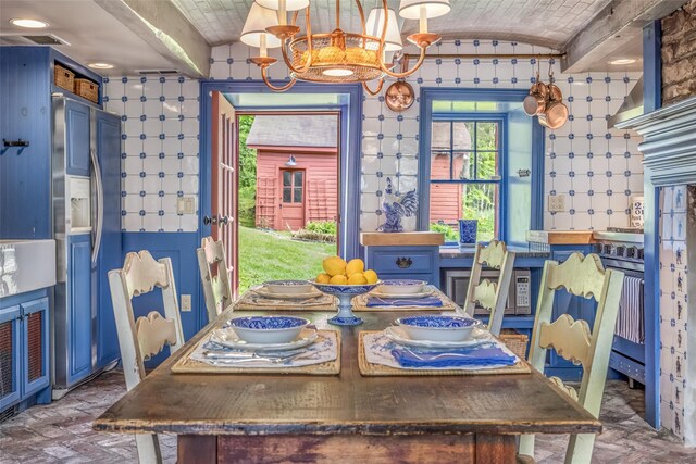 1282 Old Post Rd, Ulster Park, NY 12487 - dining area featuring a chandelier, brick floors, and lofted ceiling