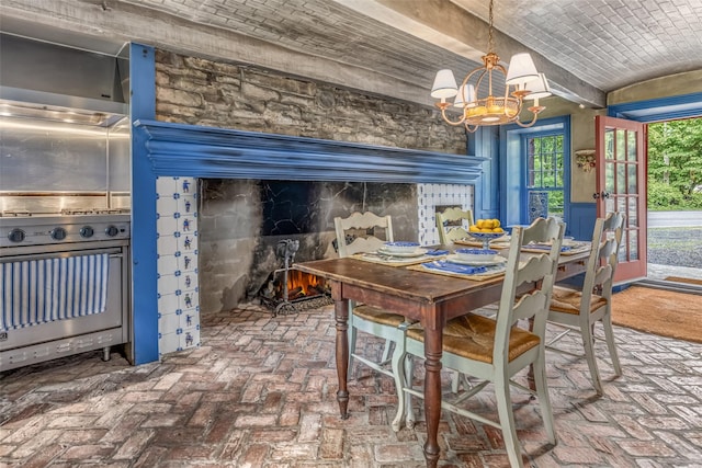 1282 Old Post Rd, Ulster Park, NY 12487 - dining area featuring brick floors, a chandelier, lofted ceiling, and a lit fireplace
