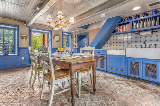 1282 Old Post Rd, Ulster Park, NY 12487 - dining area featuring brick ceiling, a chandelier, brick floors, and a wainscoted wall