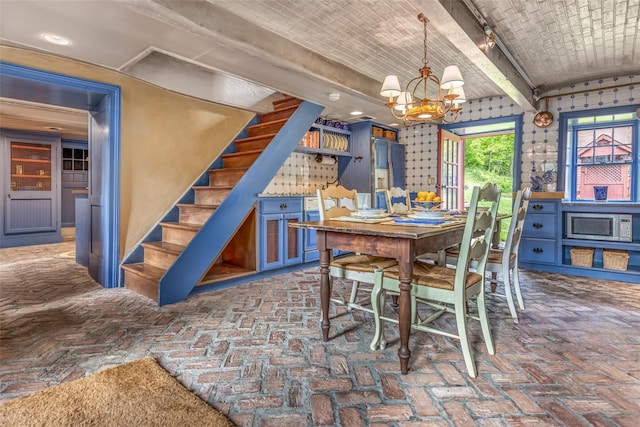 1282 Old Post Rd, Ulster Park, NY 12487 - dining space featuring a chandelier, stairway, and brick flooring