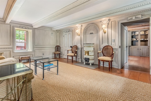 1282 Old Post Rd, Ulster Park, NY 12487 - living area with wood-type flooring, beam ceiling, a decorative wall, and crown molding