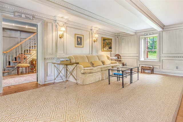 1282 Old Post Rd, Ulster Park, NY 12487 - living area with a decorative wall, ornamental molding, stairs, wood finished floors, and beamed ceiling