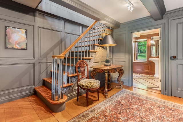 1282 Old Post Rd, Ulster Park, NY 12487 - sitting room with a decorative wall, stairway, wood finished floors, crown molding, and beamed ceiling