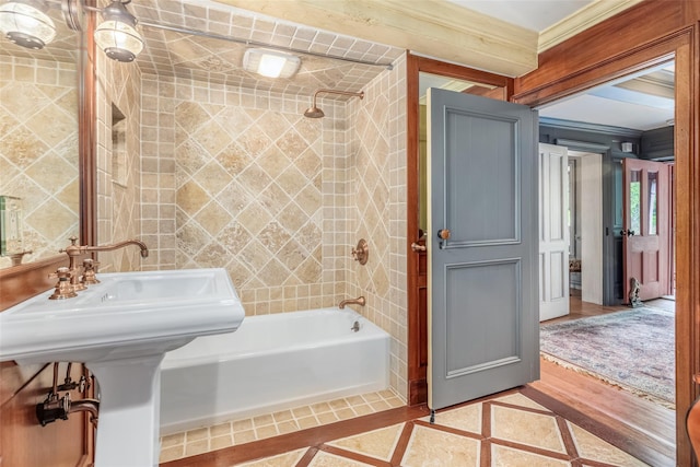 1282 Old Post Rd, Ulster Park, NY 12487 - full bathroom featuring inlaid floor details, washtub / shower combination, ornamental molding, and tile patterned flooring