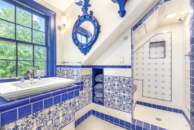 1282 Old Post Rd, Ulster Park, NY 12487 - bathroom with tiled shower, wainscoting, a sink, and tile walls
