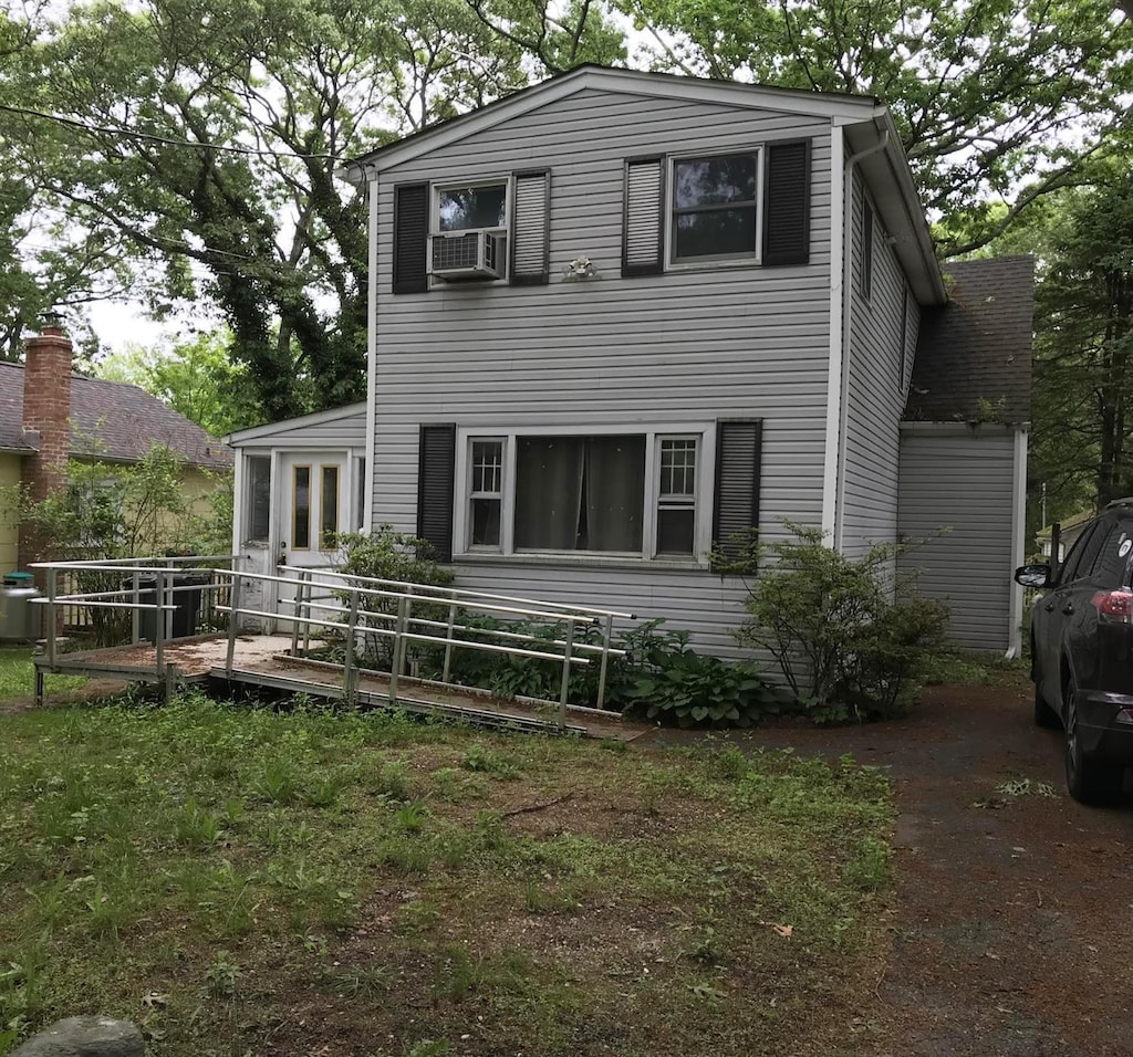 27 Atlantic Dr, Sound Beach, NY 11789 - view of front of property featuring a wooden deck and cooling unit