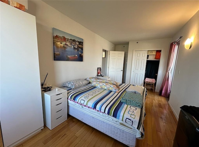136-21 Latimer Pl Unit 5H, Flushing, NY 11354 - bedroom featuring hardwood / wood-style flooring, a closet, and baseboards