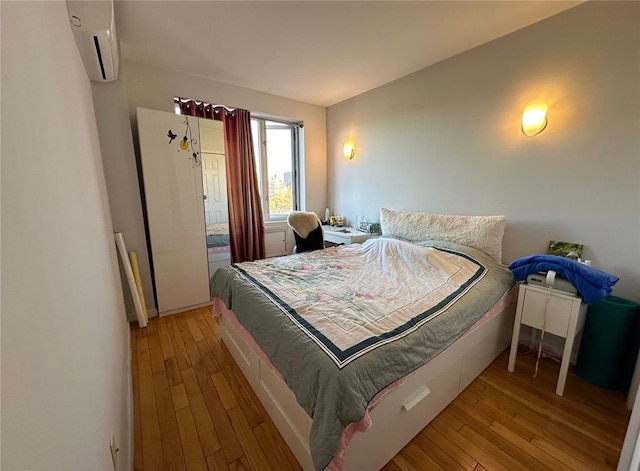 136-21 Latimer Pl Unit 5H, Flushing, NY 11354 - bedroom with a wall mounted air conditioner and wood finished floors
