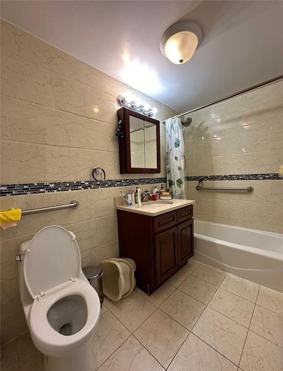 136-21 Latimer Pl Unit 5H, Flushing, NY 11354 - full bath featuring tile walls, shower / bathtub combination with curtain, vanity, marble finish floors, and toilet