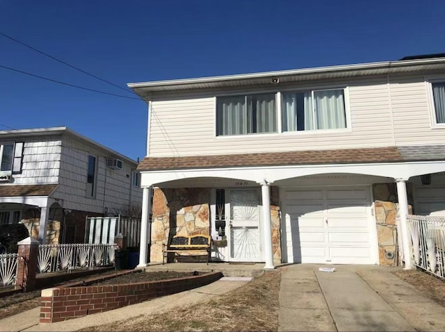 154-11 17th Ave, Whitestone, NY 11357 - view of front of property featuring an attached garage, stone siding, a porch, and driveway