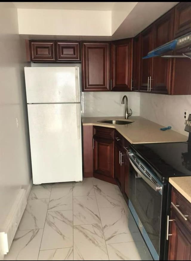 154-11 17th Ave, Whitestone, NY 11357 - kitchen with electric range, freestanding refrigerator, a sink, under cabinet range hood, and light countertops