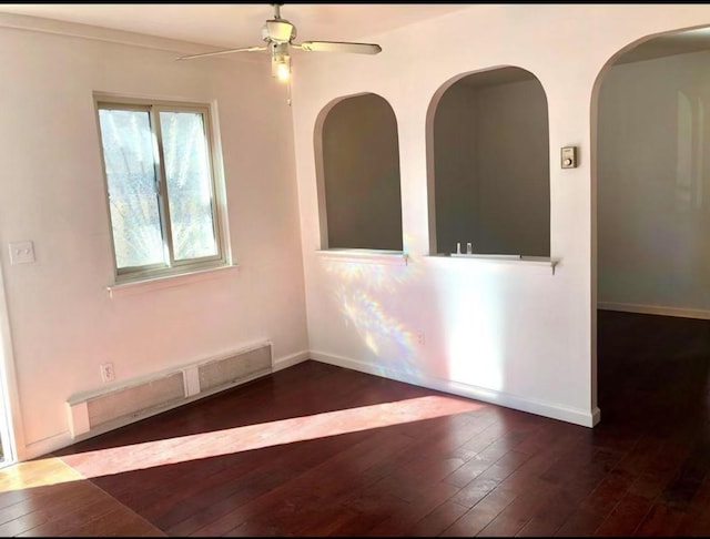 154-11 17th Ave, Whitestone, NY 11357 - empty room with wood-type flooring, a ceiling fan, baseboards, and arched walkways