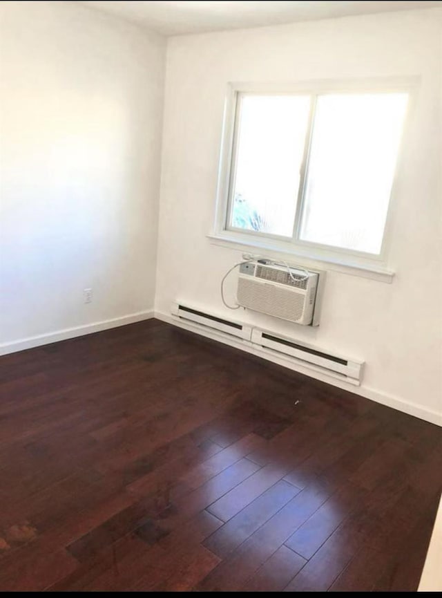 154-11 17th Ave, Whitestone, NY 11357 - empty room with healthy amount of natural light, dark wood-style flooring, a baseboard radiator, and baseboards