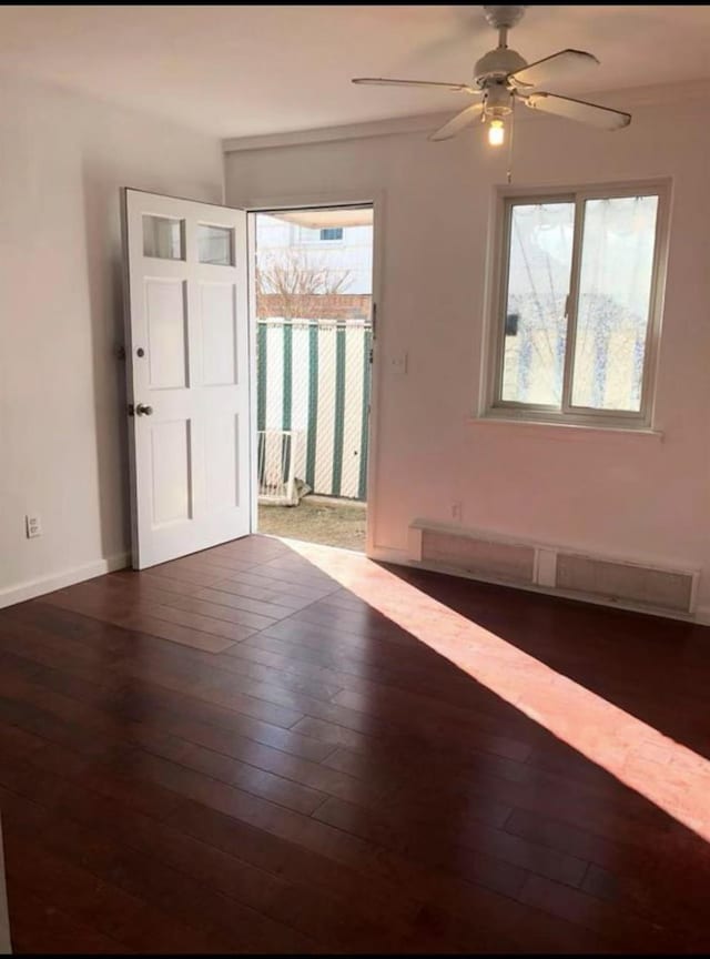 154-11 17th Ave, Whitestone, NY 11357 - empty room featuring baseboard heating, a ceiling fan, wood finished floors, and baseboards