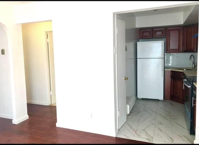 154-11 17th Ave, Whitestone, NY 11357 - kitchen with freestanding refrigerator, a sink, arched walkways, electric range, and light countertops