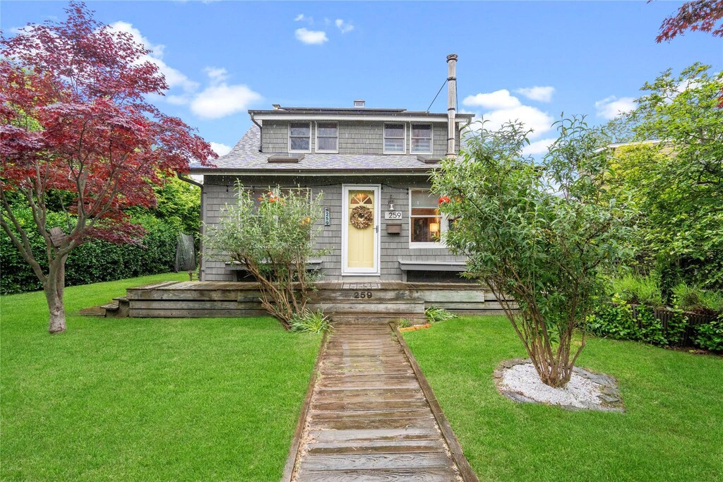 259 Foster Ave, Sayville, NY 11782 - view of front facade featuring a front yard and roof with shingles