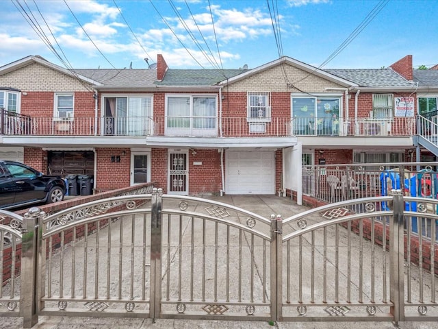 115-09 Linden Blvd, South Ozone Park, NY 11420 - multi unit property featuring brick siding, a fenced front yard, a garage, a shingled roof, and driveway