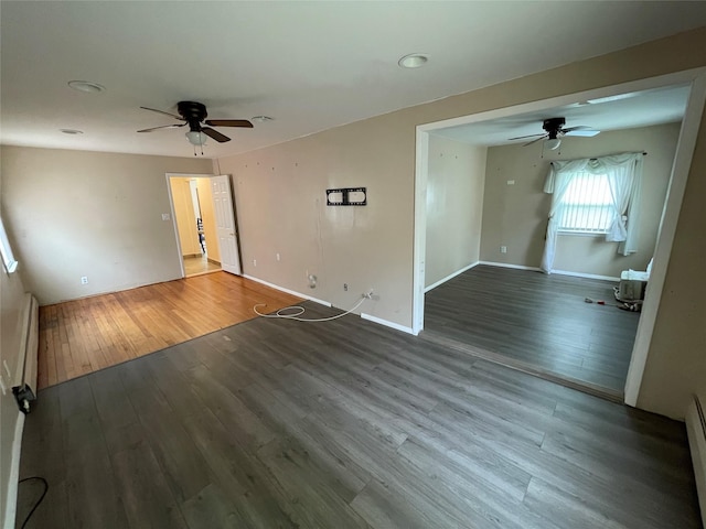 74 Webster Ave, West Islip, NY 11795 - empty room featuring ceiling fan, wood finished floors, a baseboard heating unit, and baseboards