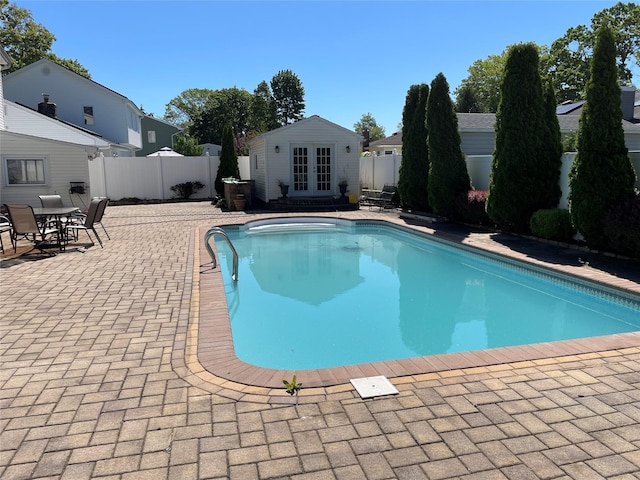 74 Webster Ave, West Islip, NY 11795 - view of pool with french doors, a fenced backyard, a storage structure, and a patio