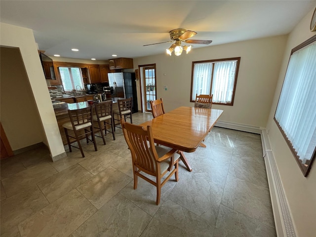 74 Webster Ave, West Islip, NY 11795 - dining room with plenty of natural light, a baseboard heating unit, a ceiling fan, baseboards, and recessed lighting