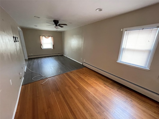 74 Webster Ave, West Islip, NY 11795 - unfurnished room with a baseboard radiator, ceiling fan, wood-type flooring, and baseboards