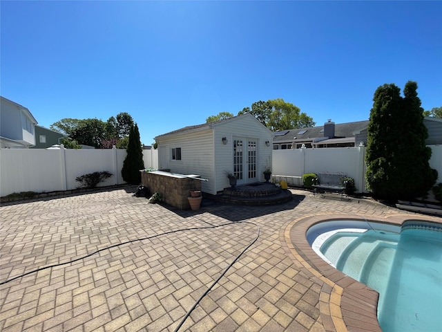 74 Webster Ave, West Islip, NY 11795 - rear view of house featuring french doors, a patio, a fenced backyard, and an outbuilding