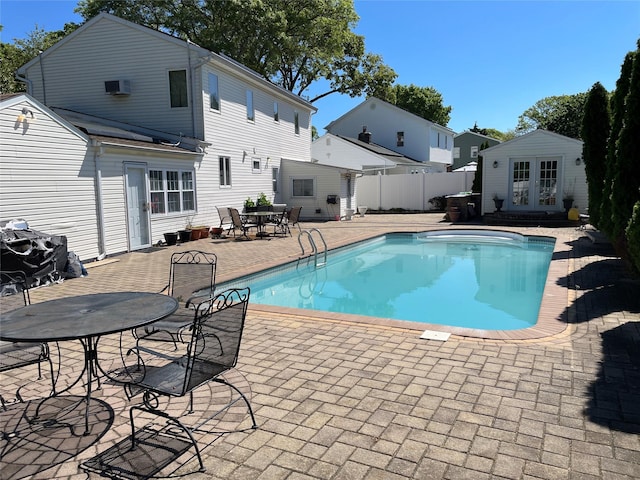 74 Webster Ave, West Islip, NY 11795 - view of swimming pool with french doors, a patio area, an outdoor structure, outdoor dining area, and a storage structure