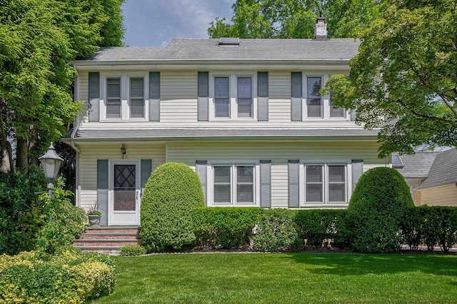 23 S Sixth St, Locust Valley, NY 11560 - view of front of house with a chimney, a front yard, and entry steps