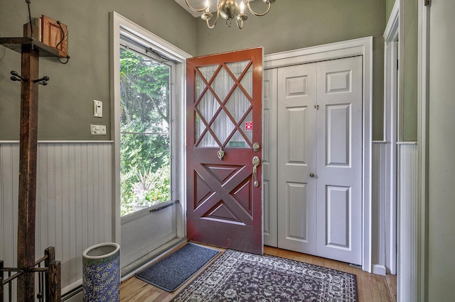 23 S Sixth St, Locust Valley, NY 11560 - entryway featuring a chandelier, light wood finished floors, and wainscoting